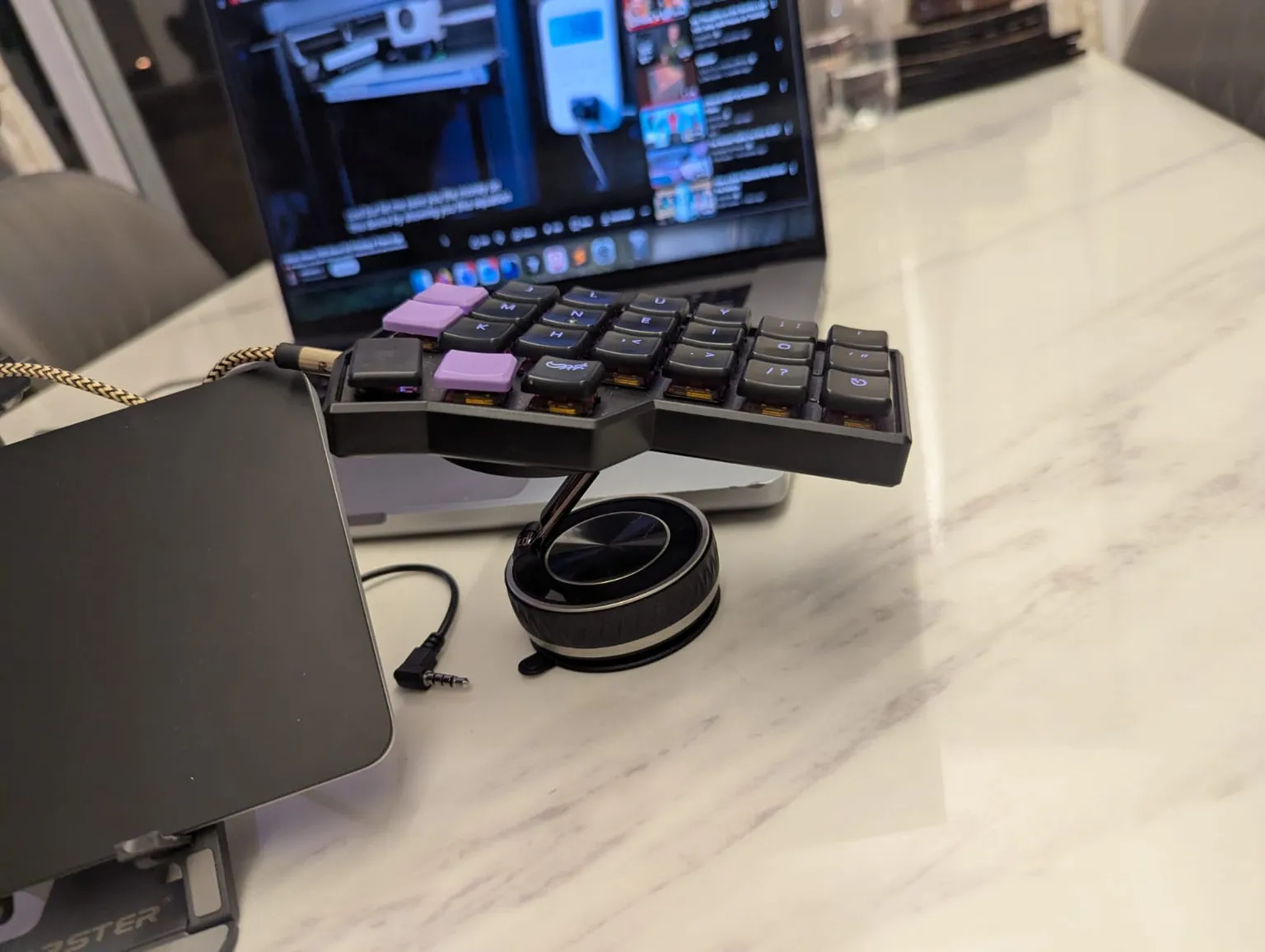 A MagSafe phone stand holding up one half of the keyboard, looking very intimidating